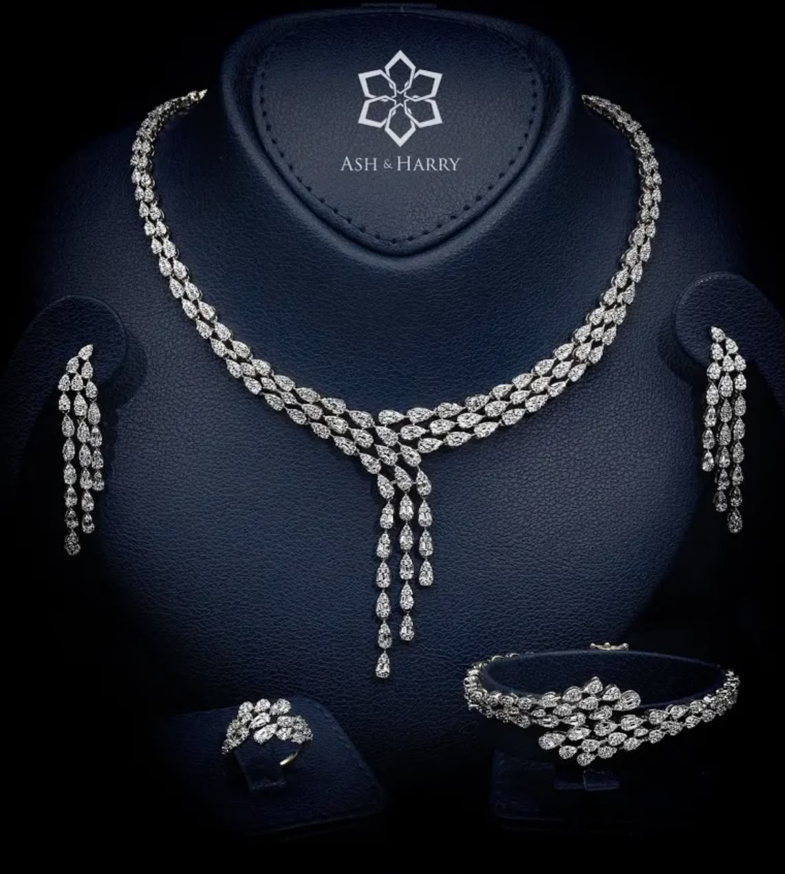 The Salma Modern White Bridal Full Set is contemporary bridal luxury with a confident edge — a double-row pear-cut choker that descends into two distinctly asymmetric pear-drop cascades at the centerpiece, falling at different lengths for an architectural sense of movement.